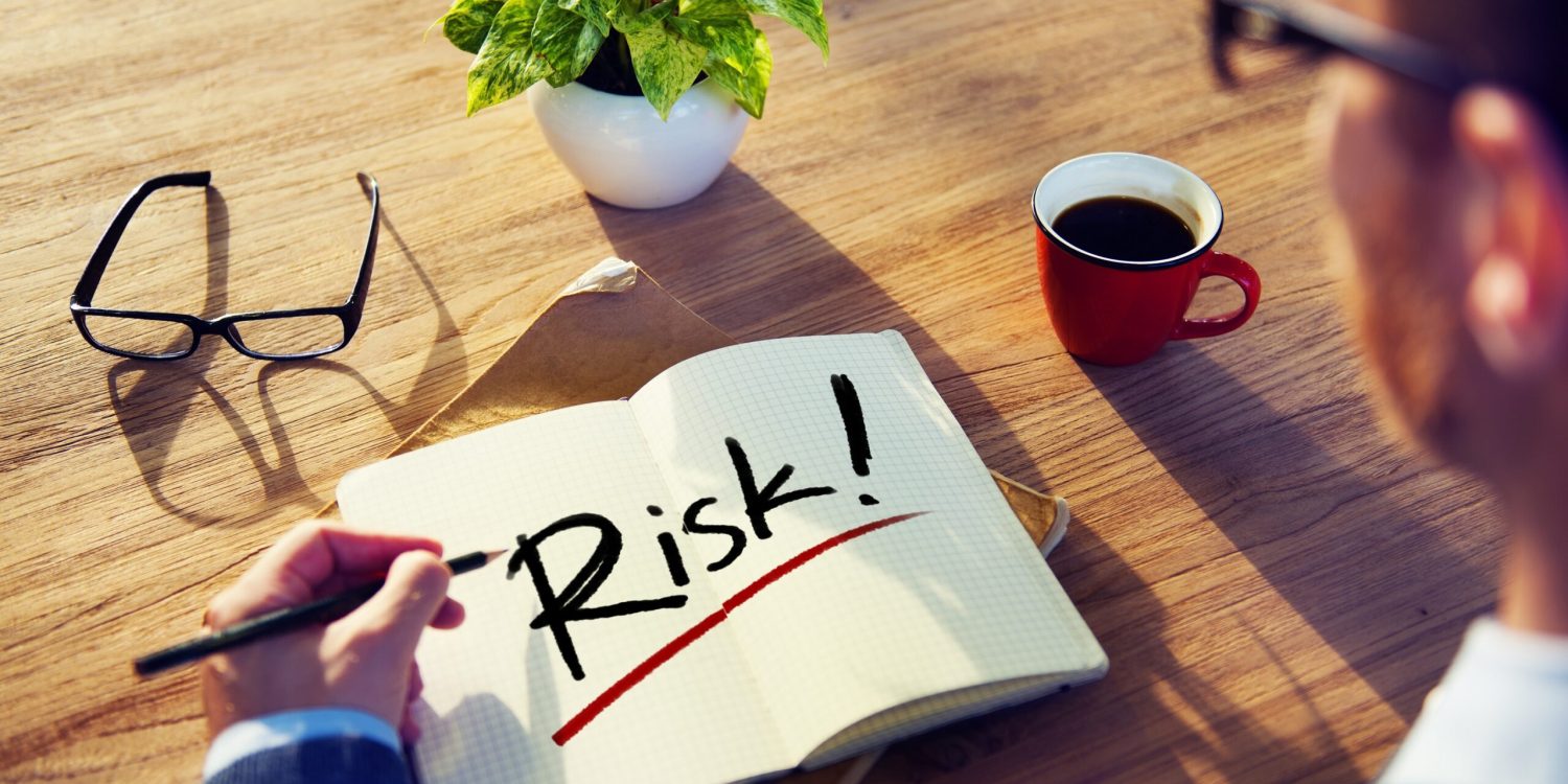 Man with a Notepad with Text Risk